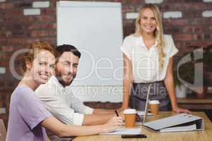 Portrait of happy business people during presentation in office