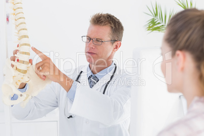 Doctor explaining anatomical spine to his patient