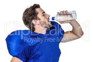 American football player drinking water