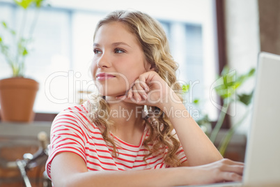 Businesswoman with hand on chin in office