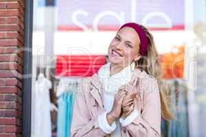 Smiling woman standing in front of window