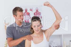 Doctor stretching a young woman arm