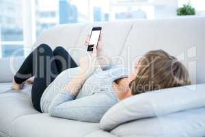 Full length of woman using smartphone at home