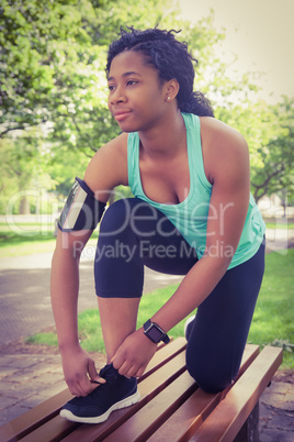 Fit woman tying her shoelace