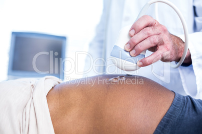 Doctor performing ultrasound on woman