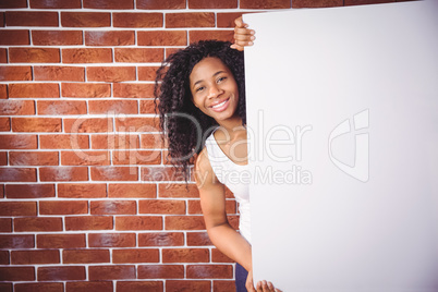 Smiling woman holding white board