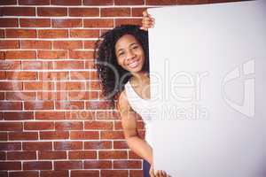 Smiling woman holding white board