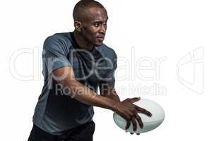 Confident sportsman in position to throw rugby ball