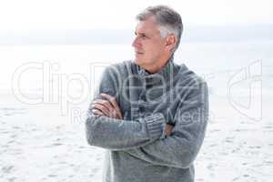 Man with crossed arms looking away