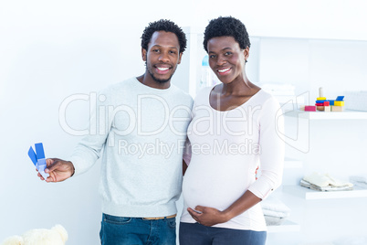 Portrait of smiling wife while husband holding color swatches