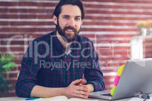 Portrait of smiling creative editor with laptop