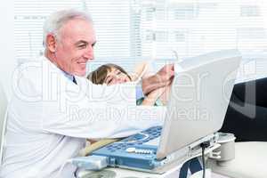 Doctor doing ultrasound test on pregnant woman