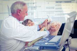 Male doctor doing ultrasound test on pregnant woman