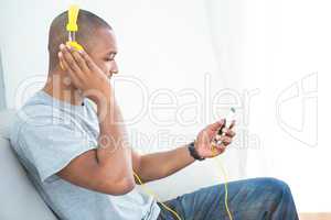 Young man listening music on smartphone