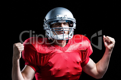 Portrait of American football player cheering with clenched fist