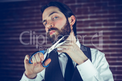 Portrait of man holding cutting beard with scissors