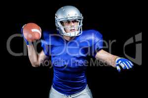 Serious American football player throwing ball