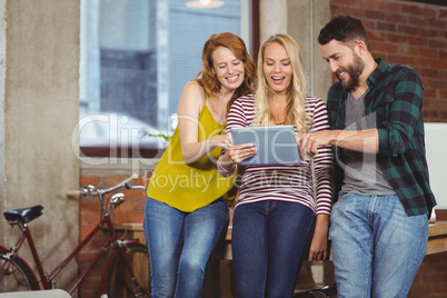 Colleagues looking towards digital tablet