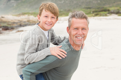 Father giving his son a piggy back