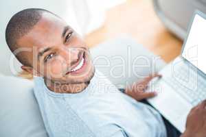 Cheerful young man with laptop