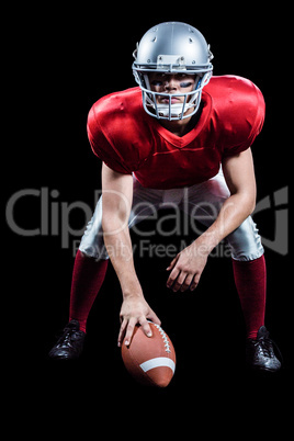 American football player placing ball while playing