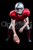 American football player placing ball while playing