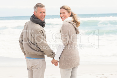 Happy couple holding hands while walking