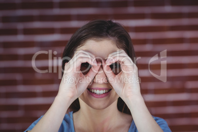 Woman holding hands as binoculars