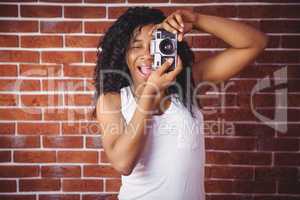 Hipster smiling and holding camera