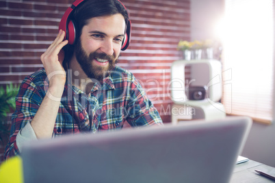 Happy businessman listening  music at office