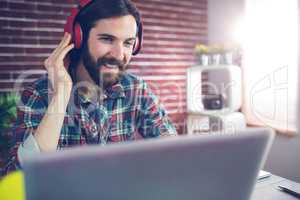 Happy businessman listening  music at office