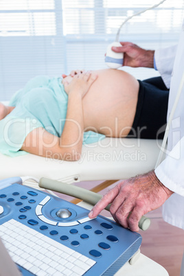 Male doctor examining pregnant woman