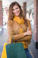 Portrait of smiling woman with shopping bags looking at camera