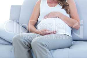 Pregnant woman relaxing on sofa