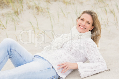 Woman lying down on the sand