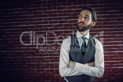 Confident hipster with arms crossed looking away