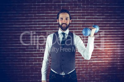 Portrait of smiling man holding dumbbell