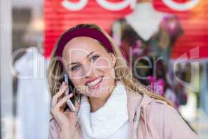 Smiling woman phoning with smartphone