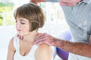 Woman relaxing while therapist massaging
