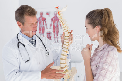 Doctor explaining anatomical spine to his patient