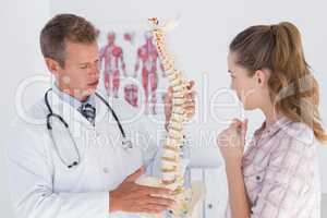 Doctor explaining anatomical spine to his patient