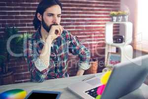 Thoughtful businessman with hand on chin