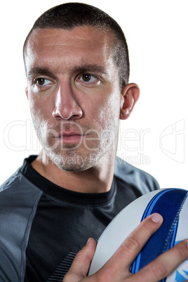 Close-up of confident rugby player holding ball