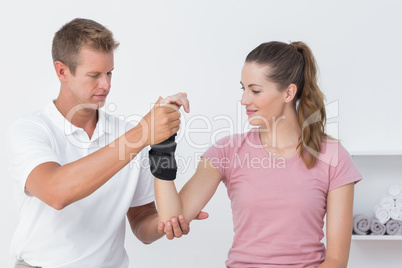 Doctor examining a woman wrist