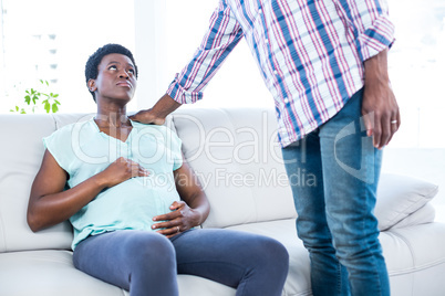 Pregnant woman sitting on sofa