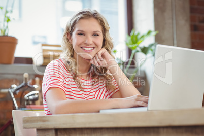 Portrait of happy smiling businesswoman with laptop in bright of