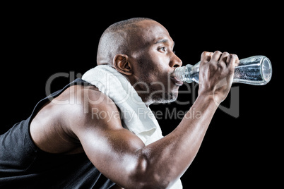 Close-up of muscular man drinking water