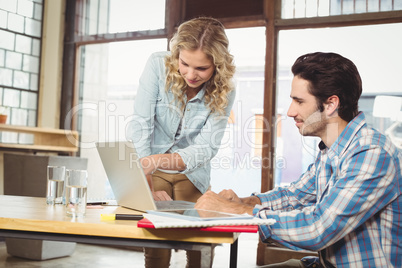 Woman explaining colleague in office