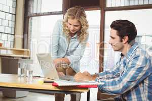 Woman explaining colleague in office