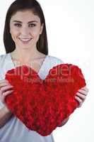 Woman holding heart shape cushion